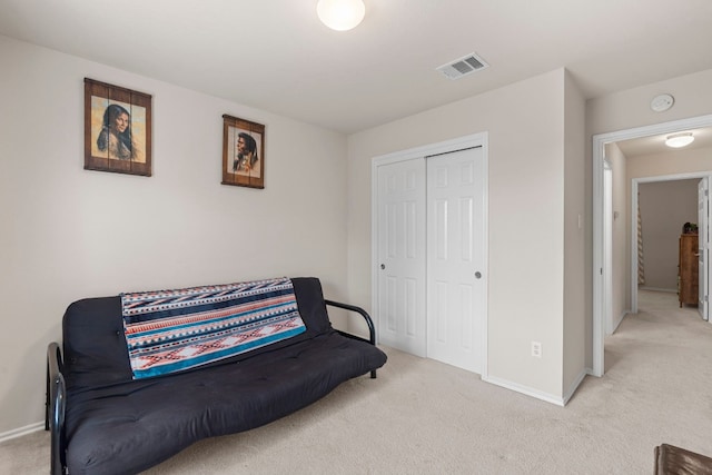 sitting room featuring light colored carpet