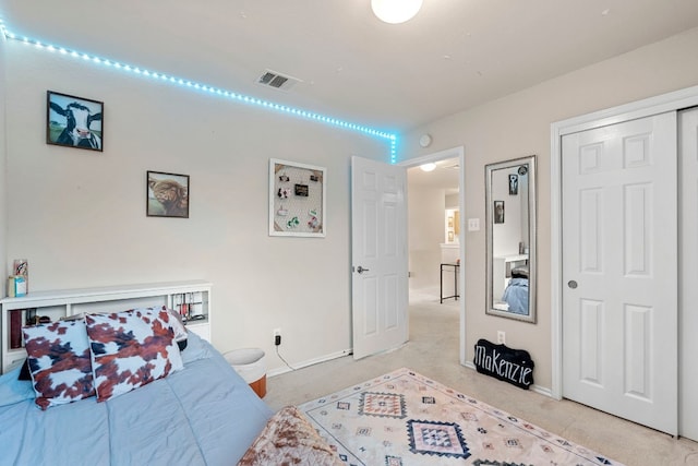 bedroom with light colored carpet and a closet