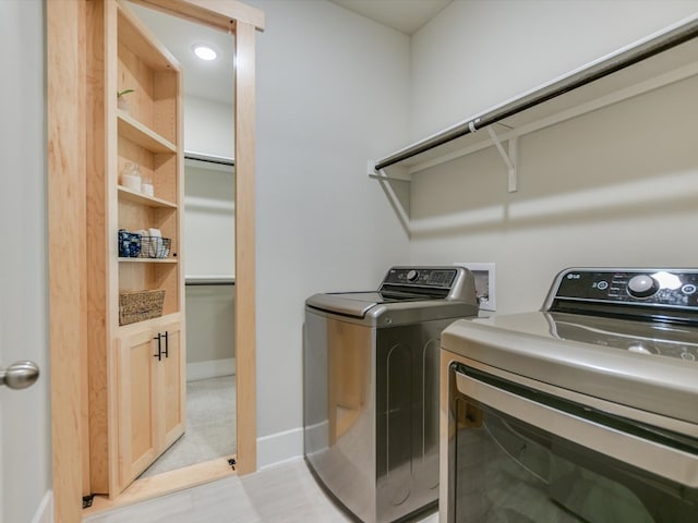 laundry room with washing machine and clothes dryer