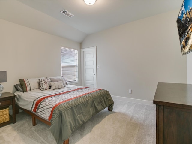 carpeted bedroom featuring lofted ceiling