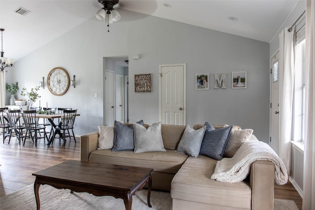 living room with light hardwood / wood-style flooring, ceiling fan, and high vaulted ceiling