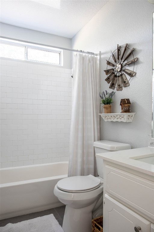 full bathroom featuring shower / tub combo, a textured ceiling, vanity, and toilet