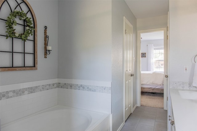 bathroom with tile patterned floors, vanity, and a bathing tub