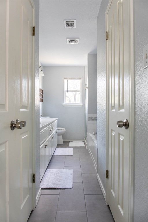 full bathroom with enclosed tub / shower combo, tile patterned floors, vanity, and toilet