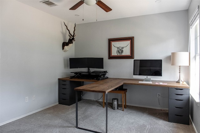 carpeted office space featuring ceiling fan