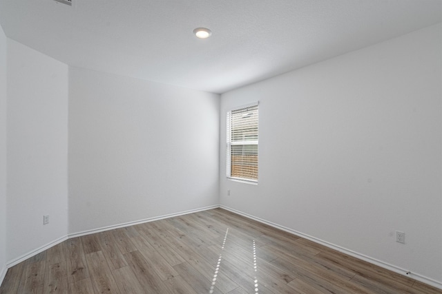 spare room featuring light hardwood / wood-style flooring