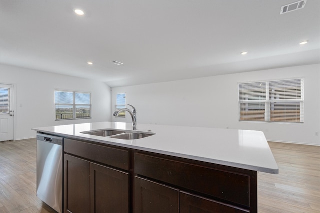 kitchen featuring a kitchen island with sink, dishwasher, light hardwood / wood-style flooring, and sink