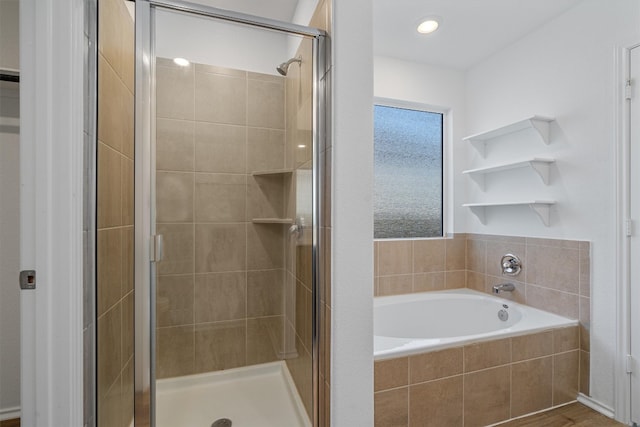 bathroom featuring separate shower and tub