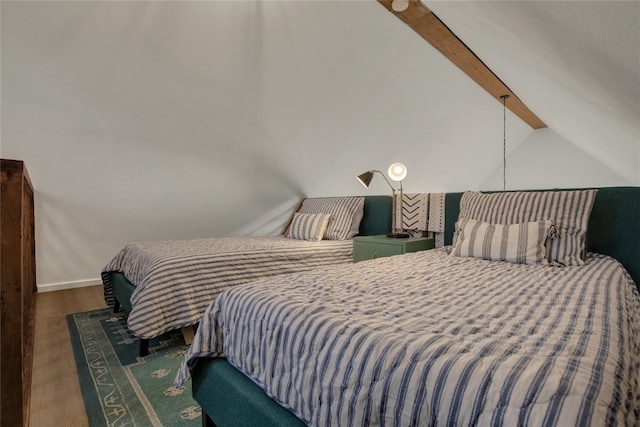 bedroom with wood-type flooring and vaulted ceiling