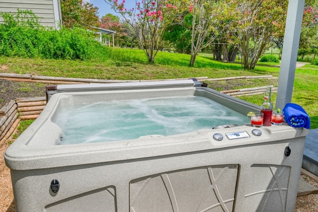 view of swimming pool with a lawn and a hot tub