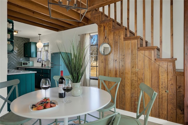 dining room featuring wooden walls