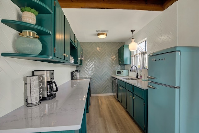 kitchen with light stone counters, fridge, light wood-type flooring, sink, and electric range