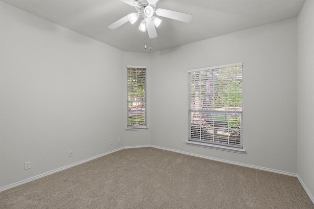 carpeted spare room with ceiling fan