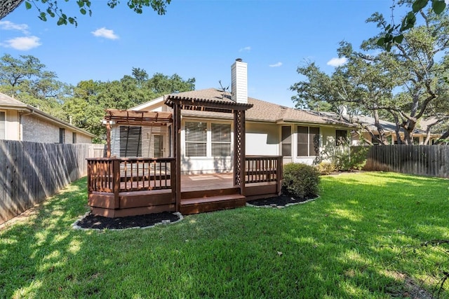 rear view of house featuring a pergola, a lawn, and a wooden deck