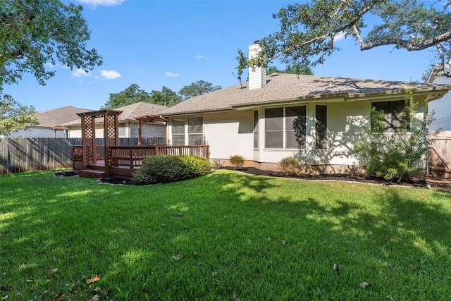 back of house with a wooden deck and a yard