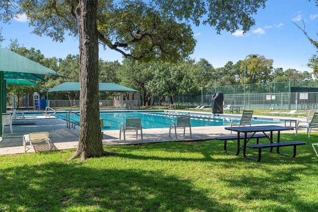 view of pool featuring a yard and a patio