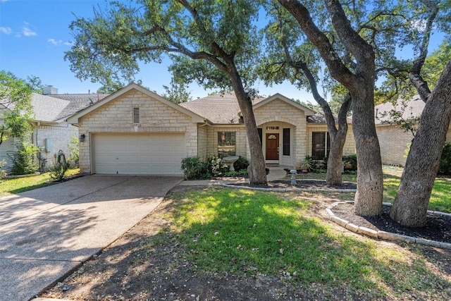 ranch-style house featuring a front yard and a garage