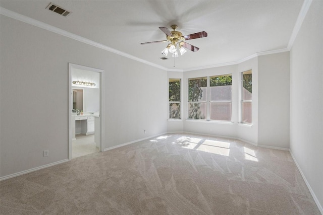 unfurnished room featuring light carpet, ceiling fan, and crown molding