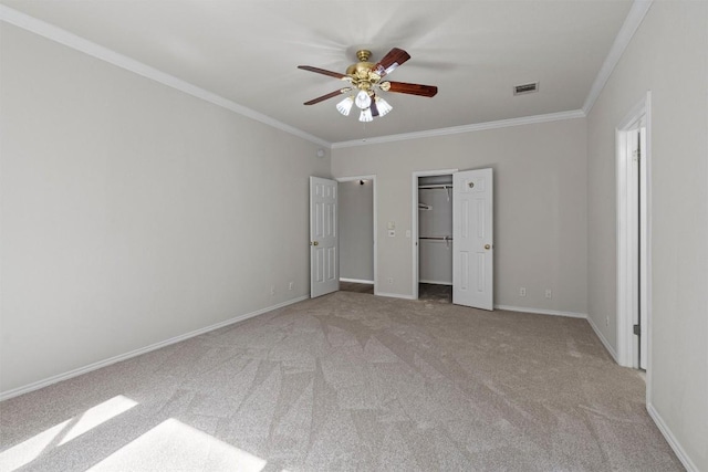 unfurnished bedroom with light colored carpet, ceiling fan, and ornamental molding