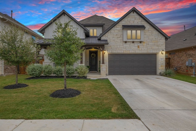 view of front of property featuring a yard and a garage