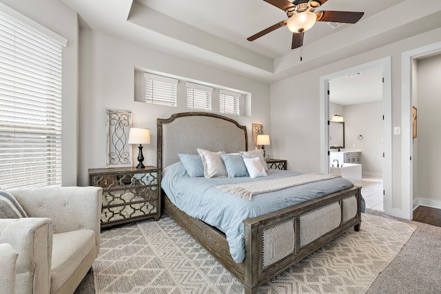 bedroom featuring ceiling fan and a tray ceiling