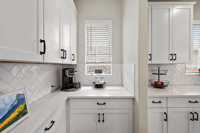 kitchen featuring decorative backsplash and white cabinetry