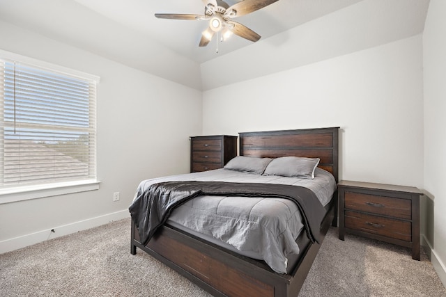 bedroom featuring ceiling fan, light colored carpet, and lofted ceiling