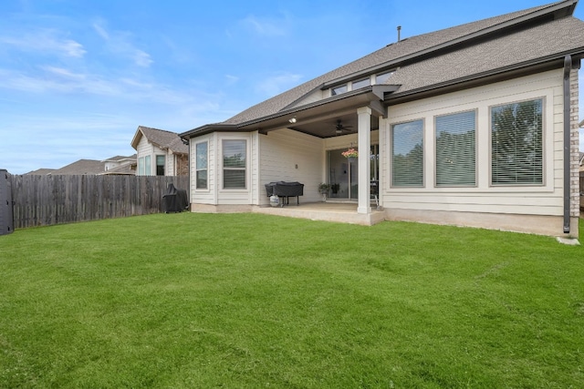 rear view of house featuring a lawn, a patio area, and ceiling fan