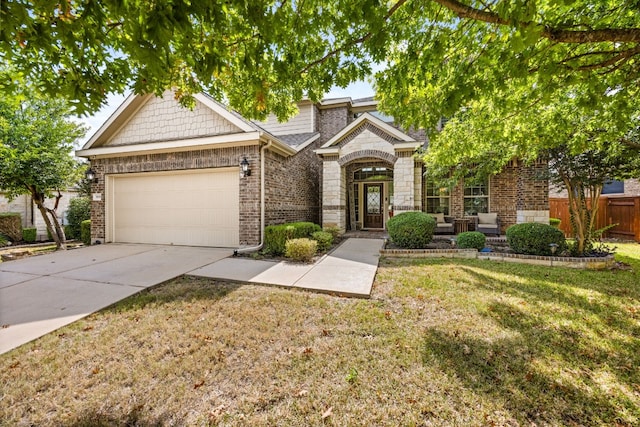 view of front of home featuring a garage and a front yard