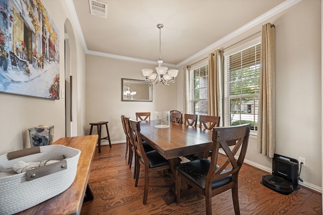 dining room with dark hardwood / wood-style flooring, a chandelier, and crown molding