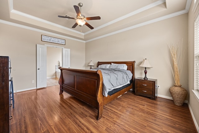 bedroom with crown molding, dark hardwood / wood-style flooring, ceiling fan, and a raised ceiling