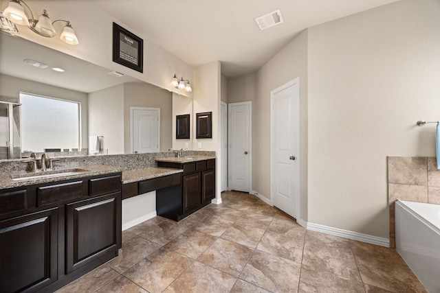 bathroom featuring a bathtub, vanity, and tile patterned floors