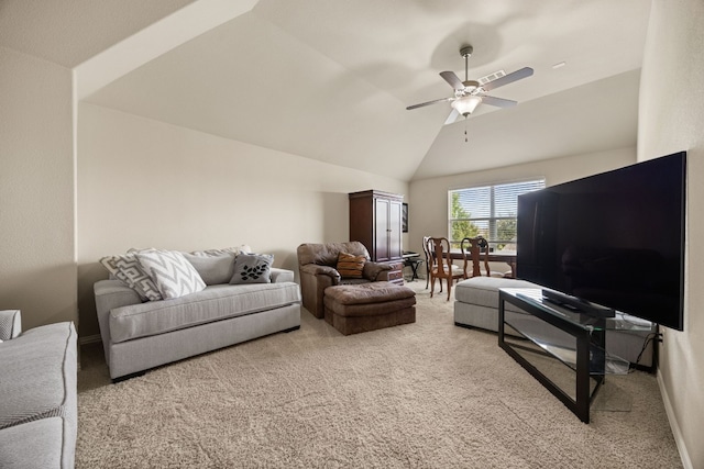 carpeted living room featuring ceiling fan and vaulted ceiling