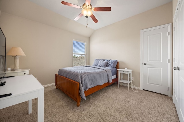 carpeted bedroom with ceiling fan and vaulted ceiling