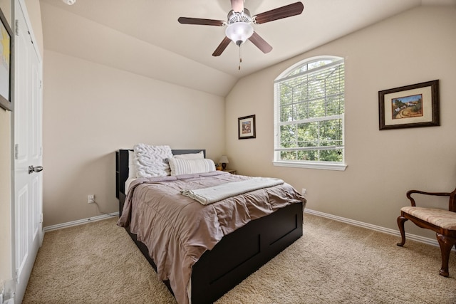 carpeted bedroom featuring ceiling fan and vaulted ceiling