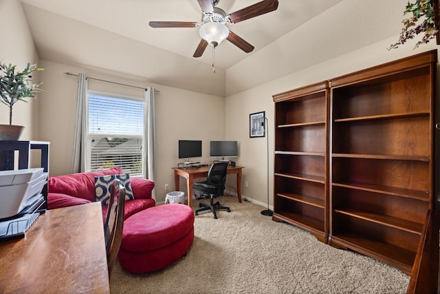 home office featuring lofted ceiling, carpet flooring, and ceiling fan