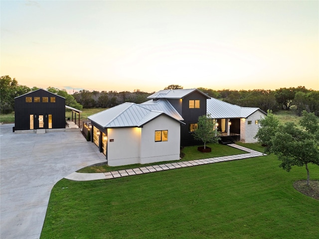 modern farmhouse style home with a lawn