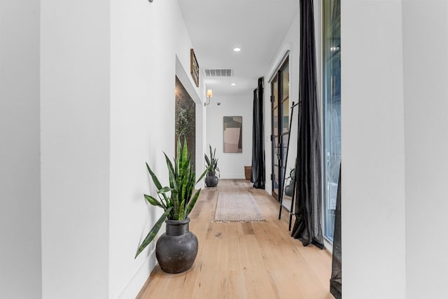 corridor with wood-type flooring