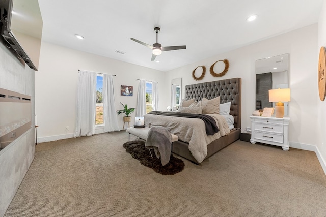 bedroom with ceiling fan and light carpet