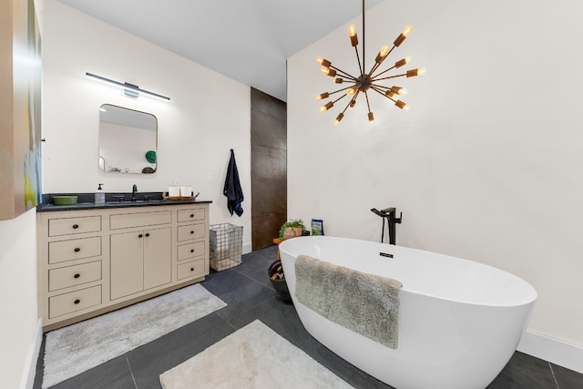 bathroom featuring a bathtub, vanity, an inviting chandelier, and tile patterned floors