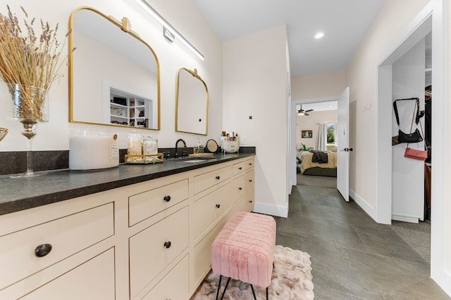 bathroom with ceiling fan, vanity, and concrete floors