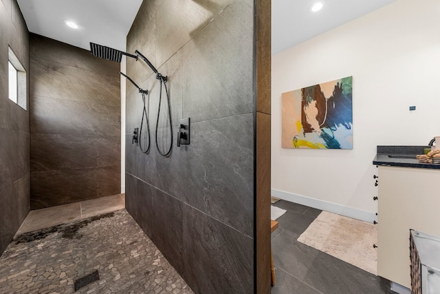 bathroom featuring a tile shower and vanity