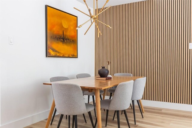 dining space featuring a chandelier and light hardwood / wood-style flooring