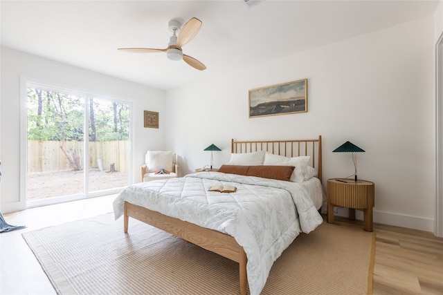 bedroom featuring ceiling fan, light hardwood / wood-style floors, and access to exterior