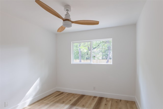 empty room with ceiling fan and light hardwood / wood-style floors