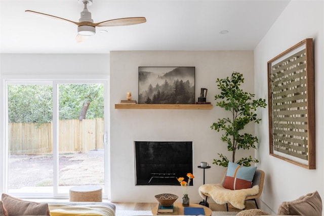 living room with hardwood / wood-style flooring and ceiling fan