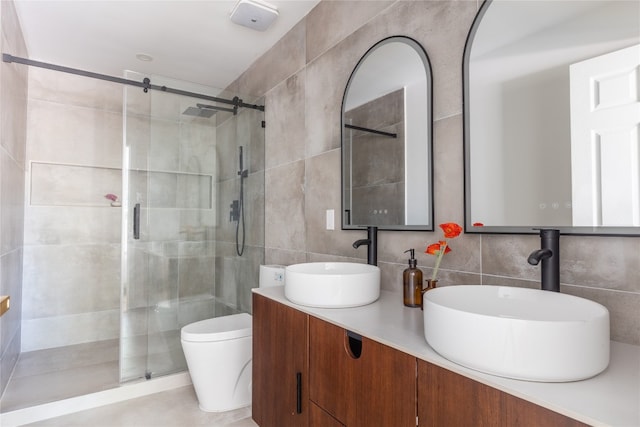 bathroom with tasteful backsplash, walk in shower, vanity, tile walls, and toilet