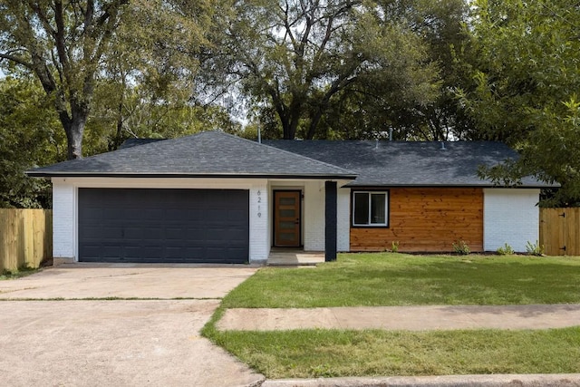 single story home featuring a front yard and a garage