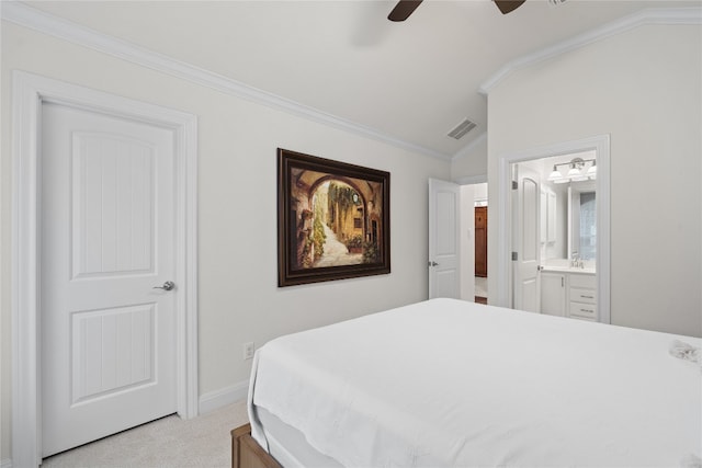 carpeted bedroom with vaulted ceiling, ceiling fan, ensuite bath, and crown molding