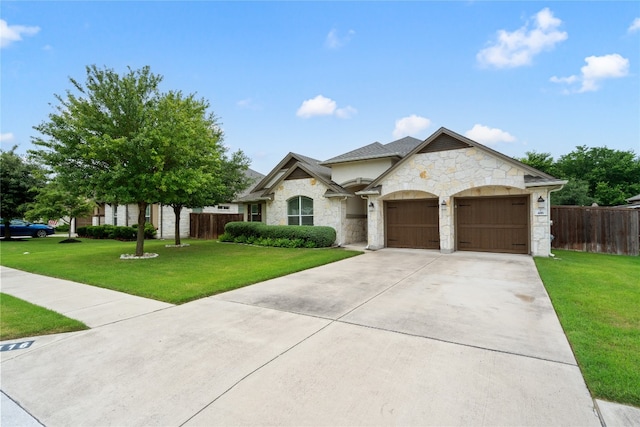 view of front of home with a front yard and a garage